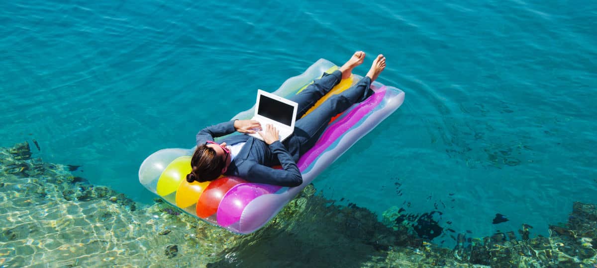 Happy Businesswoman With Laptop On Floating Mattress In Red Sea Grin